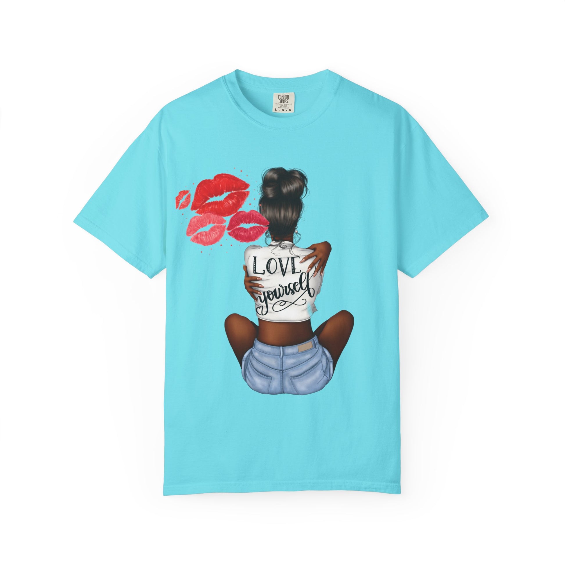 Light blue t-shirt with a graphic of a woman sitting and 'Love Yourself' text on the back, with red lip prints above. Representing a journey....